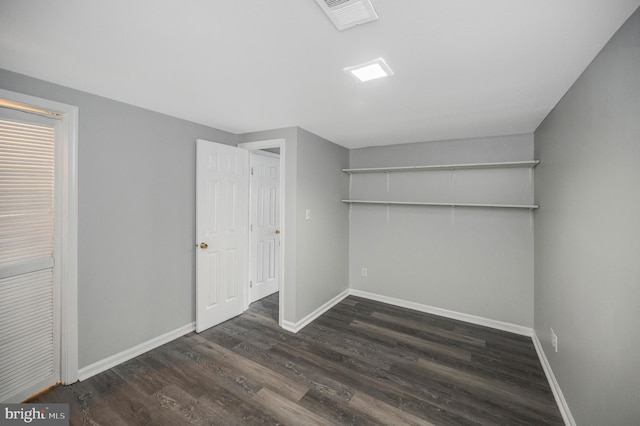 interior space with dark hardwood / wood-style floors and a closet