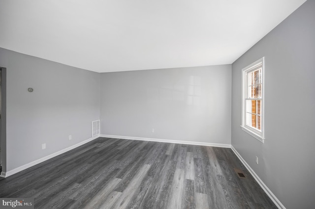 unfurnished room featuring dark hardwood / wood-style floors