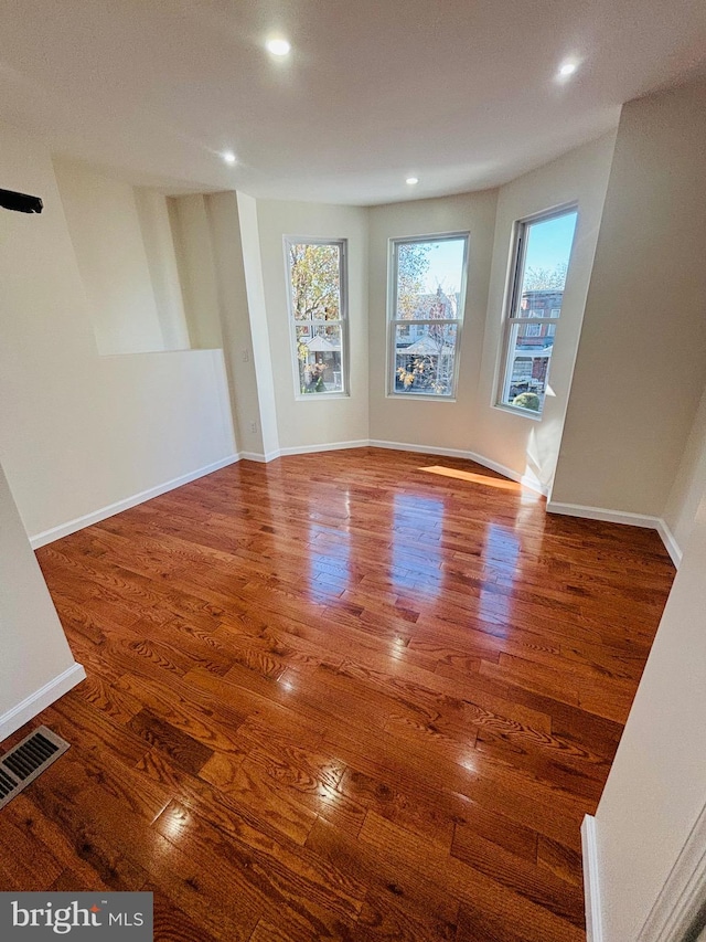 spare room with hardwood / wood-style flooring