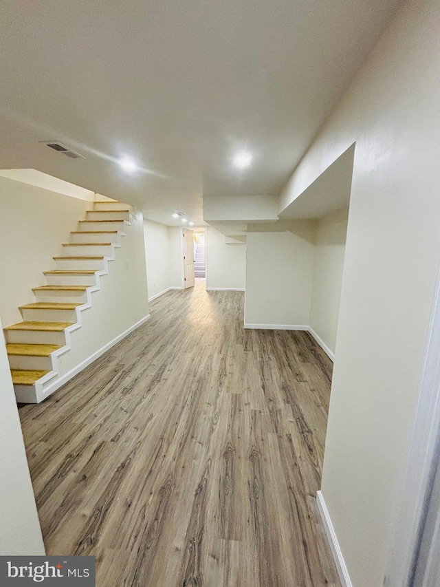 basement with hardwood / wood-style floors