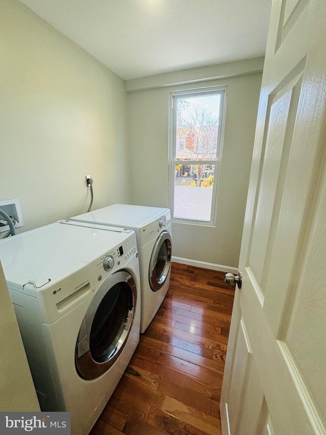 washroom with washing machine and dryer and dark wood-type flooring