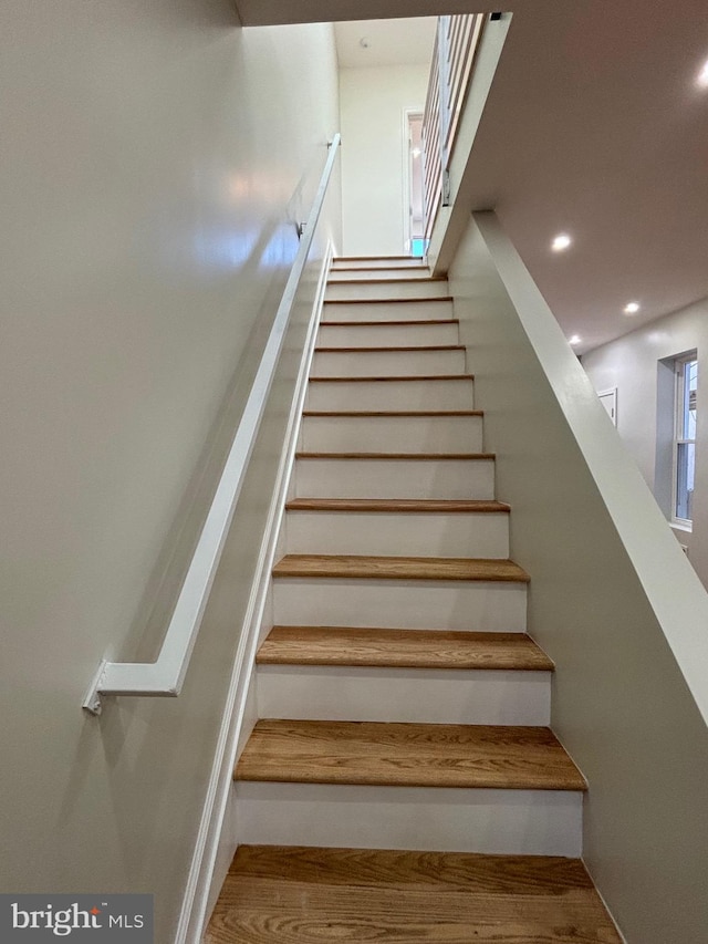 stairs with hardwood / wood-style floors