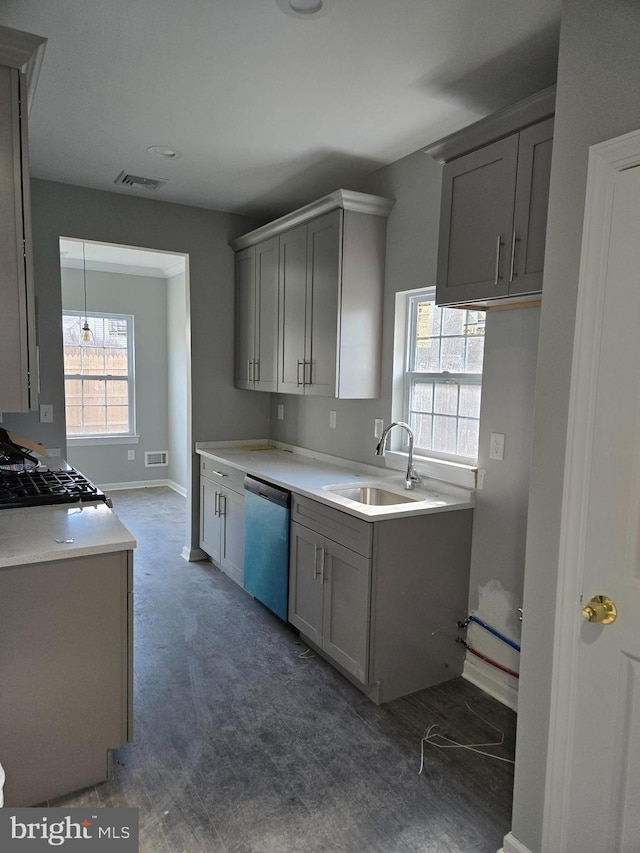 kitchen featuring stainless steel dishwasher, gray cabinets, a sink, and visible vents