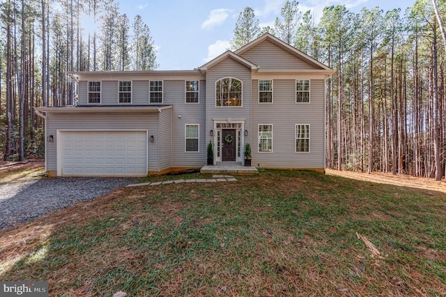 view of front of house with a front yard and a garage