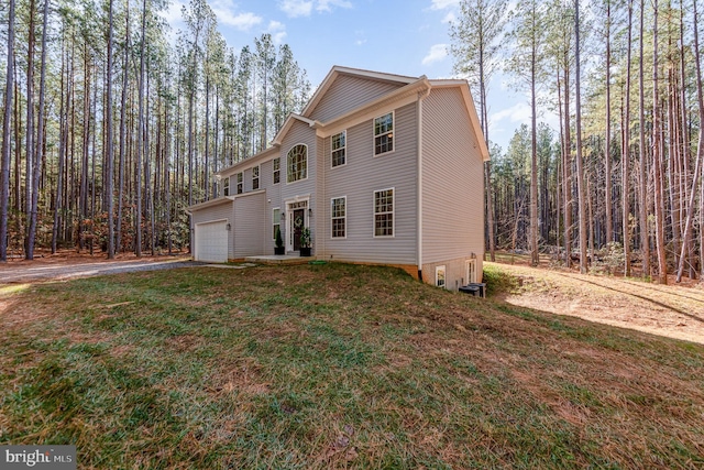 view of front of property with a front yard and a garage