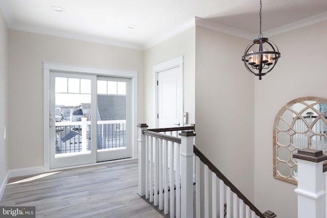 interior space featuring hardwood / wood-style flooring, ornamental molding, and a chandelier