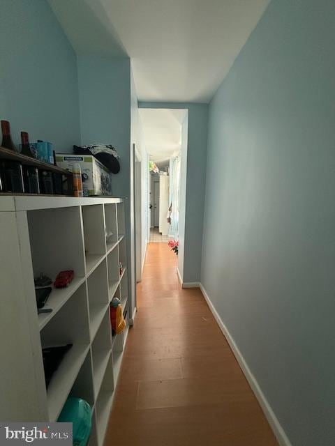 corridor with hardwood / wood-style floors