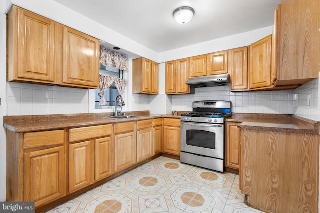 kitchen featuring decorative backsplash, sink, light tile patterned floors, and stainless steel range with gas stovetop