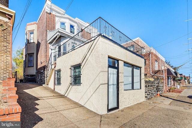 view of side of home featuring a balcony