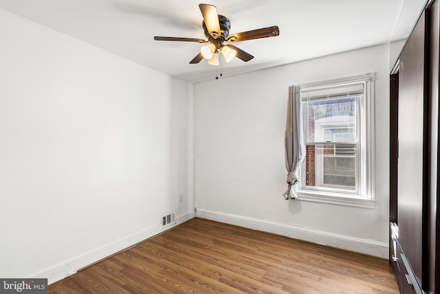 empty room featuring ceiling fan and light hardwood / wood-style flooring