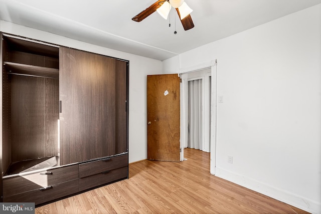 unfurnished bedroom with a closet, light hardwood / wood-style flooring, and ceiling fan