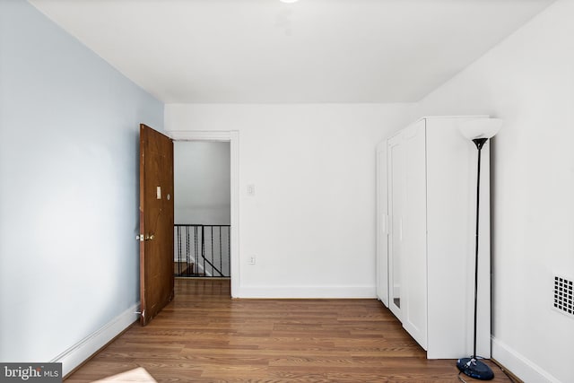 unfurnished bedroom with hardwood / wood-style flooring