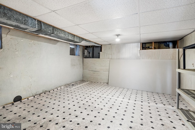 basement with a paneled ceiling