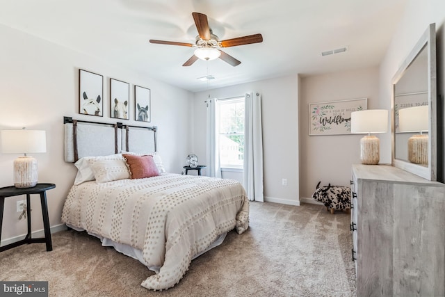 bedroom with light carpet and ceiling fan