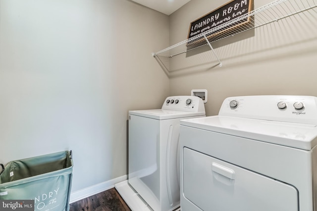 laundry area with dark hardwood / wood-style flooring and independent washer and dryer