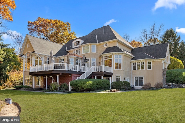 back of house with a yard and a deck