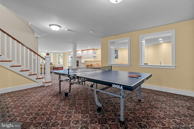 recreation room featuring carpet floors and decorative columns