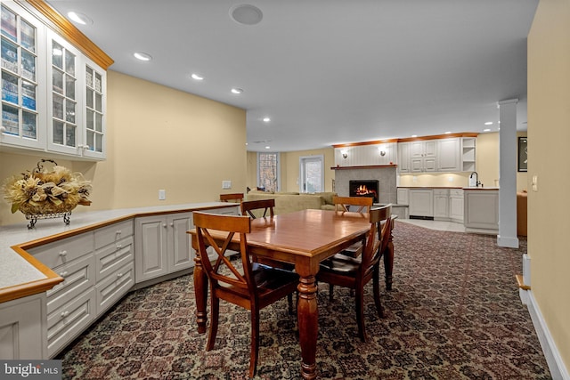 dining area with sink and dark carpet