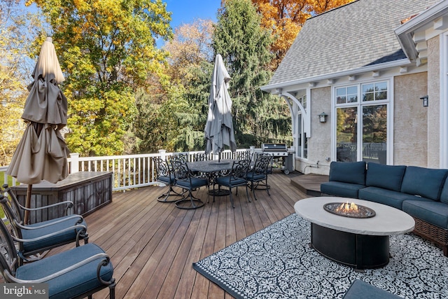 wooden deck with an outdoor living space with a fire pit