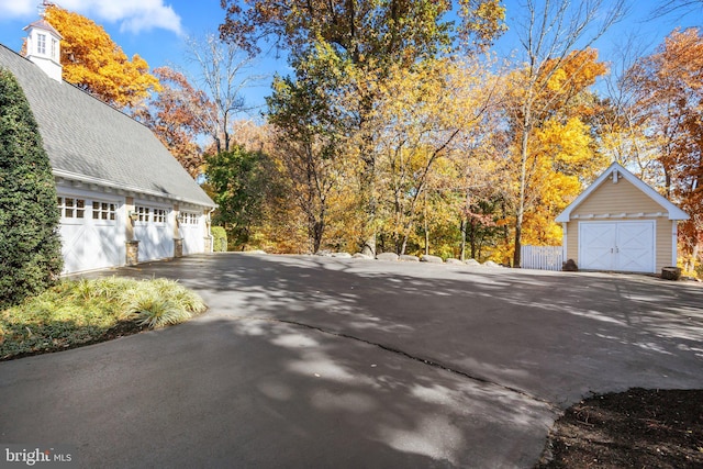 view of side of property featuring an outbuilding and a garage