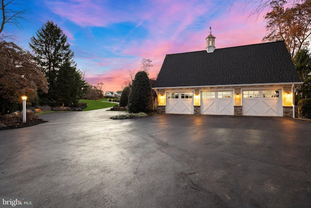 view of garage at dusk