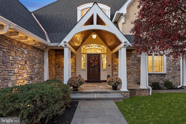 exterior entry at dusk featuring covered porch