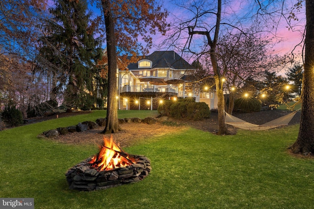 yard at dusk with a fire pit