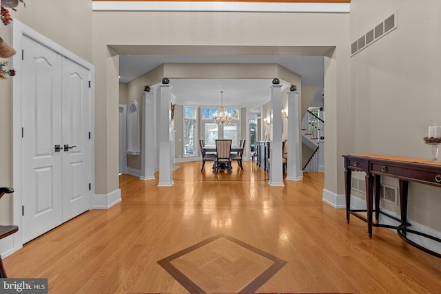 foyer featuring an inviting chandelier and light hardwood / wood-style flooring