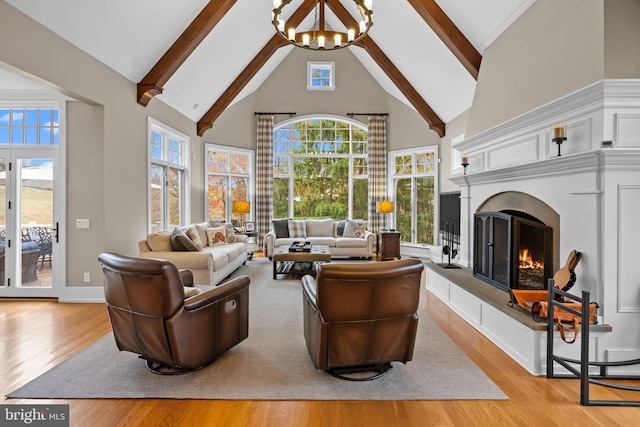 living room with beam ceiling, high vaulted ceiling, light hardwood / wood-style floors, and a chandelier