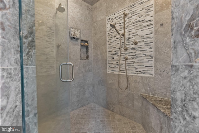 bathroom with a shower with shower door