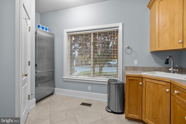 interior space with sink and stainless steel fridge