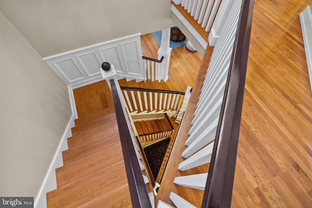 stairway featuring wood-type flooring