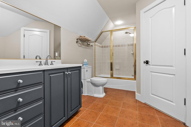 full bathroom with lofted ceiling, toilet, shower / bath combination with glass door, vanity, and tile patterned flooring