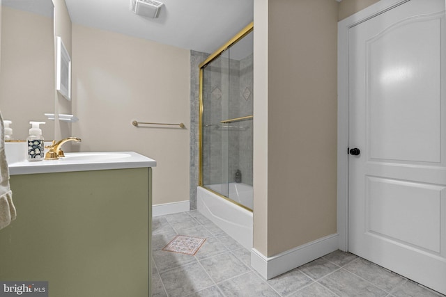 bathroom with enclosed tub / shower combo, tile patterned floors, and vanity