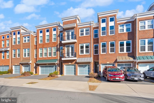 view of building exterior featuring a garage and driveway