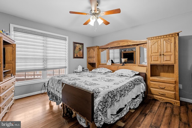 bedroom with hardwood / wood-style floors and ceiling fan