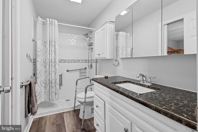 bathroom with curtained shower, toilet, vanity, and hardwood / wood-style flooring