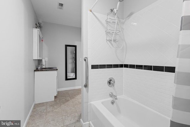 bathroom featuring vanity and tiled shower / bath combo