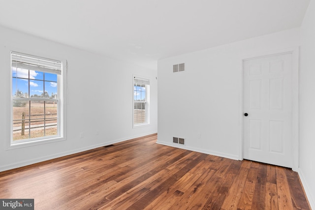 spare room featuring dark hardwood / wood-style flooring