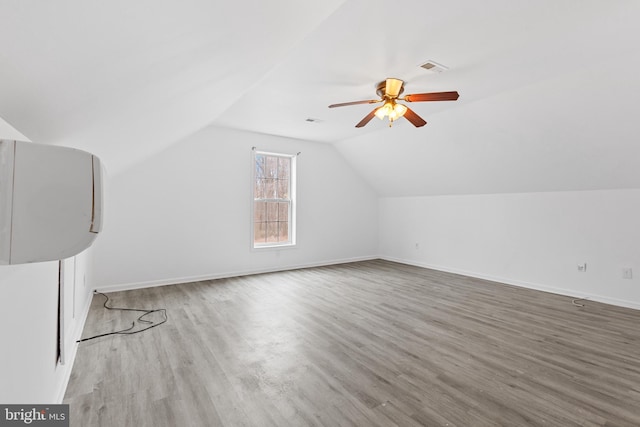 bonus room featuring ceiling fan, lofted ceiling, and light wood-type flooring