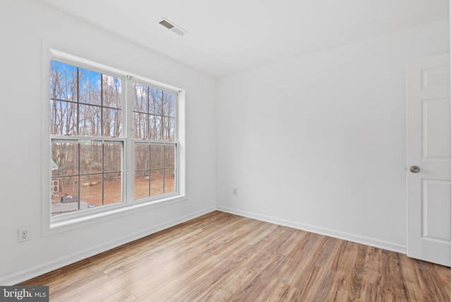 unfurnished room with light hardwood / wood-style flooring