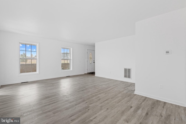 empty room with light hardwood / wood-style floors