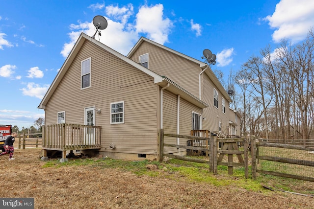 back of property featuring a wooden deck