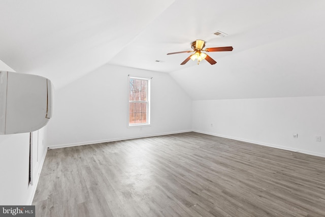 bonus room featuring light hardwood / wood-style floors, vaulted ceiling, and ceiling fan