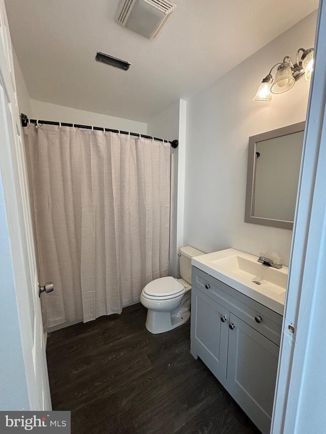 bathroom featuring hardwood / wood-style floors, vanity, and toilet