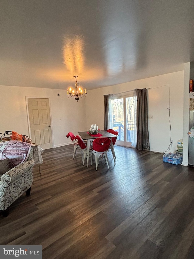 dining area featuring dark hardwood / wood-style floors and a notable chandelier