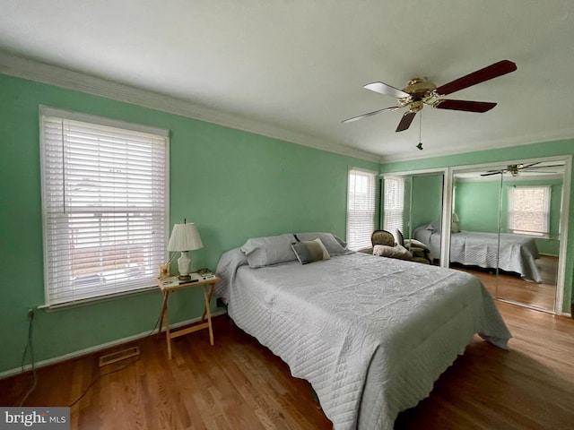 bedroom featuring hardwood / wood-style flooring, ceiling fan, and crown molding