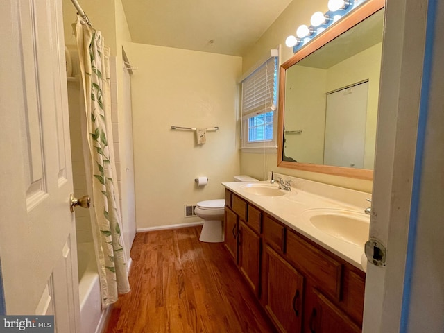 full bathroom with wood-type flooring, vanity, toilet, and shower / bathtub combination with curtain