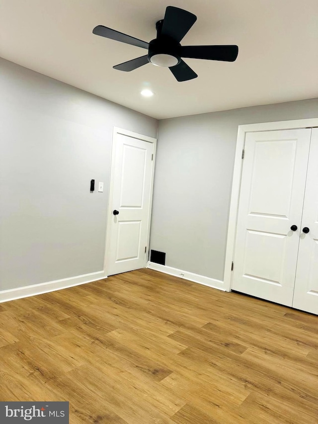 unfurnished room featuring light wood-type flooring and ceiling fan