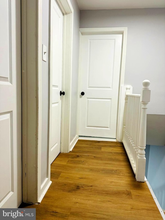 hallway with light hardwood / wood-style floors